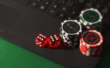Casino chips and dice on a laptop